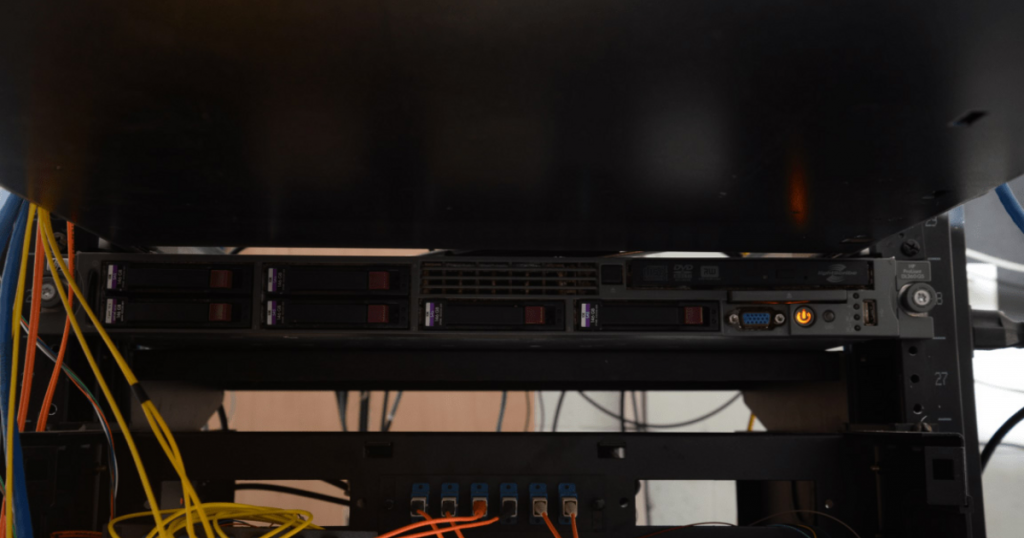 Server rack with hard drives and network cables for web server hosting